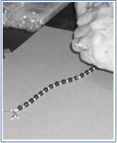 Making bracelets to sell for Cancer Research